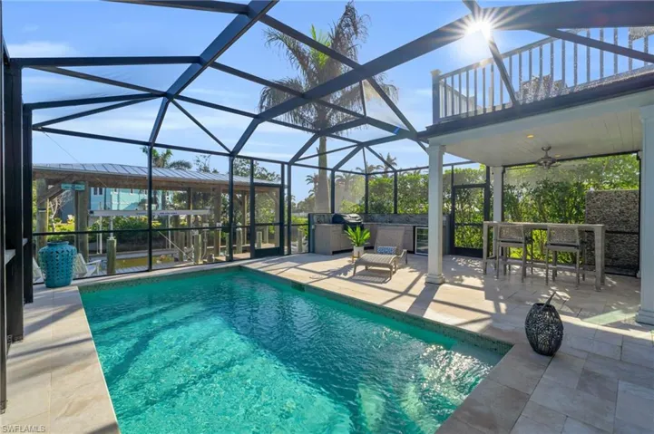 Swimming pool featuring a lanai, a patio, a sunroom, and a ceiling fan