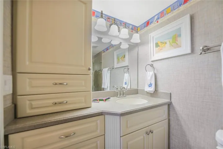 Full bathroom with vanity and curtained shower