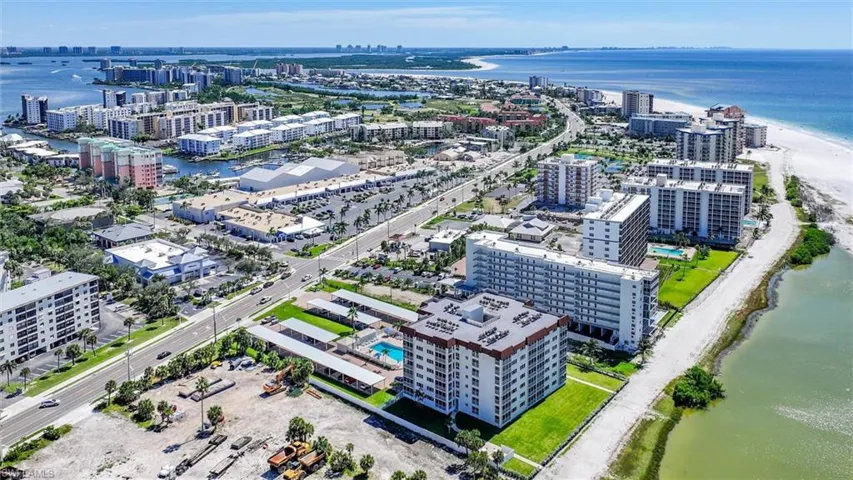 View of urban area featuring waterfront with a beach
