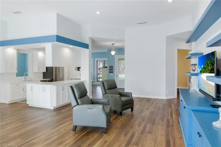 Living area featuring recessed lighting and dark wood-style flooring