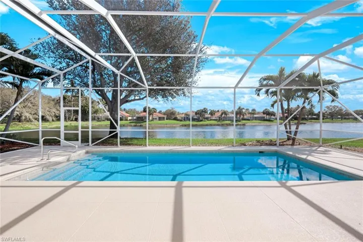 Outdoor pool with a sunroom, a lanai, a water view, and a residential view