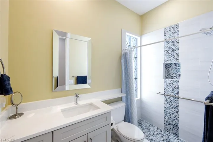 Full bath featuring vanity and a shower stall
