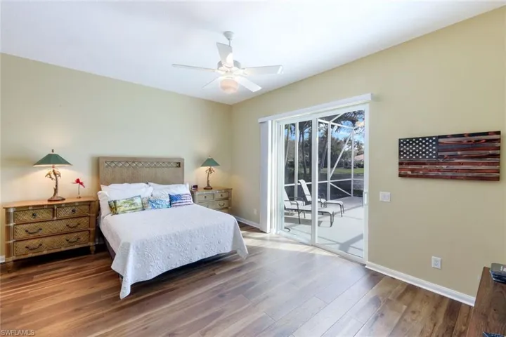 Bedroom featuring wood finished floors, access to outside, and a ceiling fan