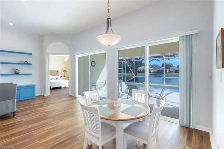 Dining area with wood finished floors and a water view