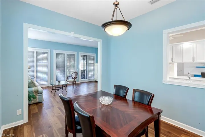 Dining room featuring dark wood-type flooring and baseboards