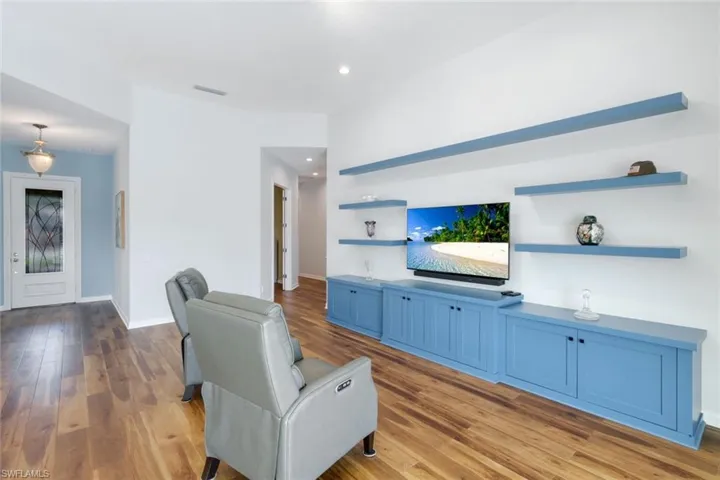 Living room featuring light wood-style flooring and recessed lighting