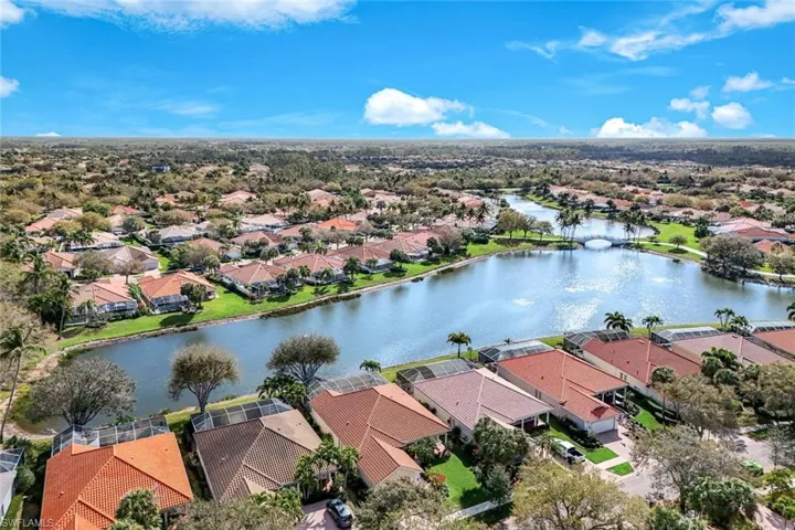 Aerial perspective of suburban area featuring a nearby body of water