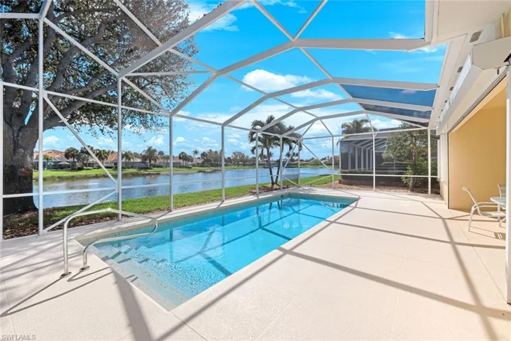 Outdoor pool featuring a sunroom, a patio area, a lanai, a water view, and a residential view