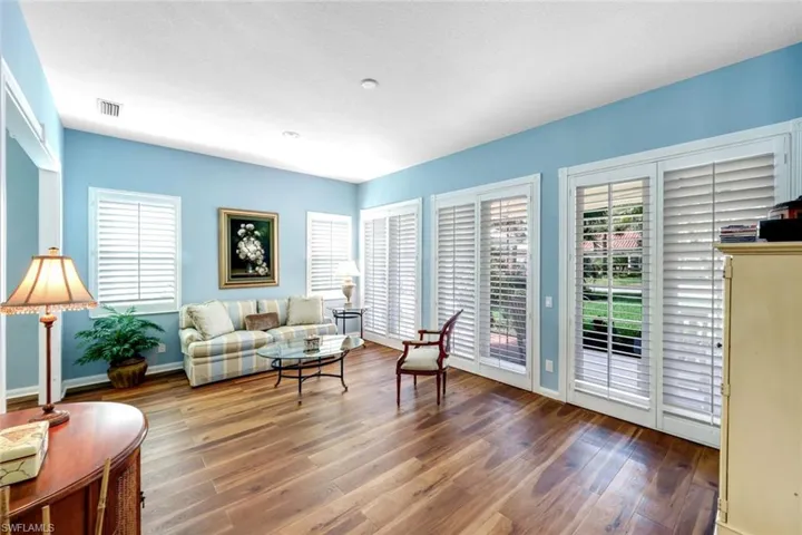 Living area featuring dark wood-style floors and plenty of natural light