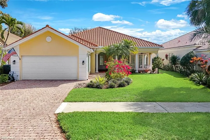 Mediterranean / spanish-style house with a front lawn, a garage, decorative driveway, stucco siding, and a tiled roof