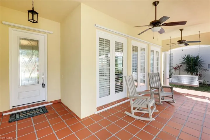 Entrance to property featuring french doors, stucco siding, ceiling fan, and a patio area