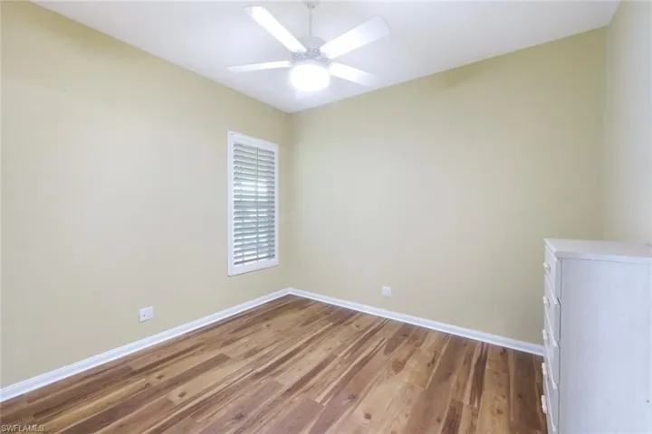 Spare room with light wood finished floors and a ceiling fan