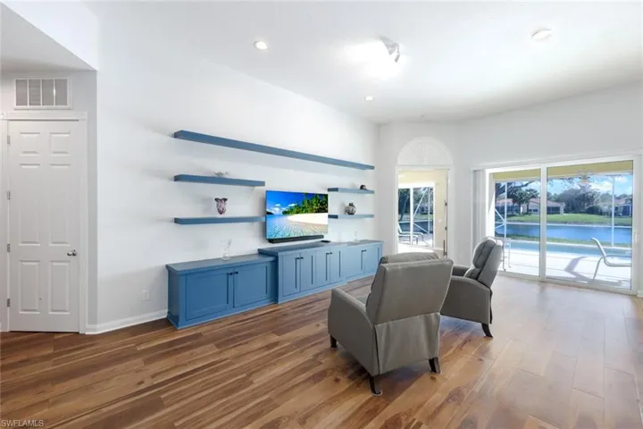 Living area featuring wood finished floors and recessed lighting