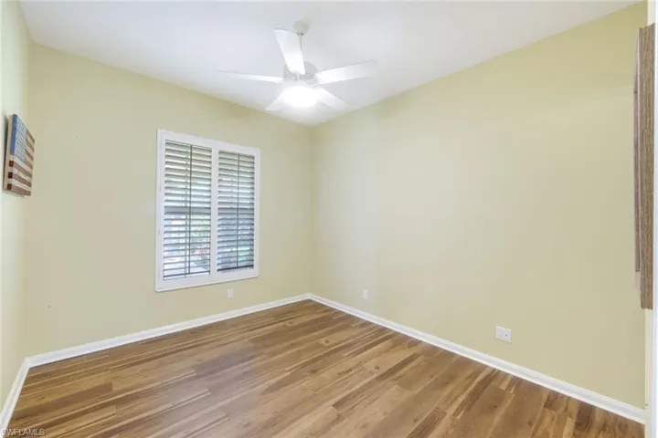 Spare room with wood finished floors and a ceiling fan