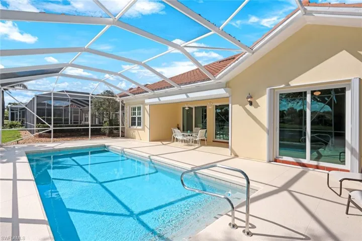 Outdoor pool featuring a patio, a sunroom, and a lanai