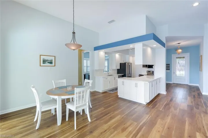 Dining space with light wood-style floors and baseboards