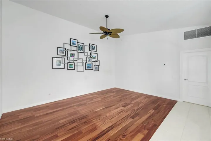 Unfurnished room featuring wood finished floors and a ceiling fan