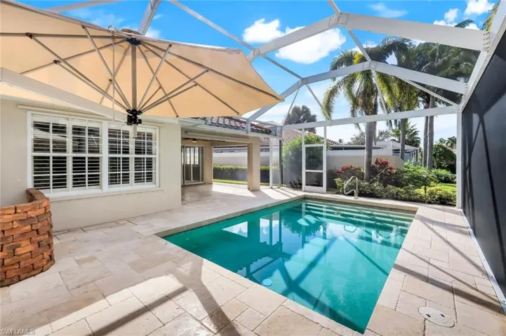 Outdoor pool featuring a patio area, a sunroom, and a lanai