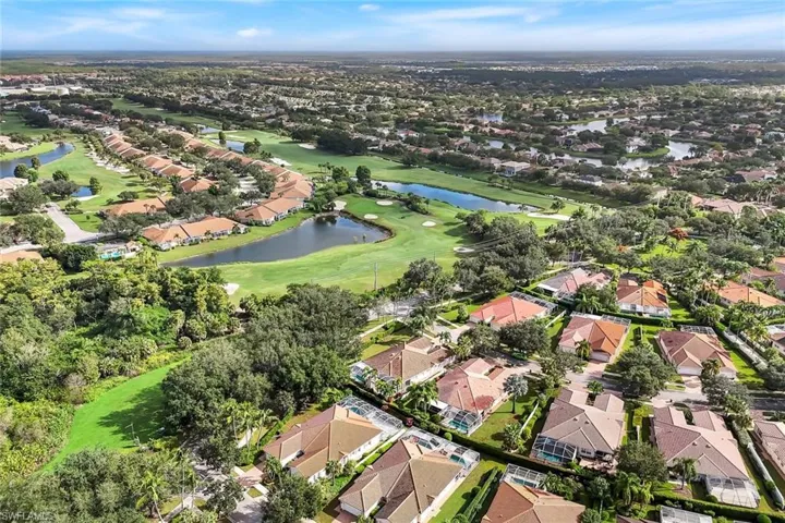 View of property location featuring nearby suburban area, a large body of water, and a golf club