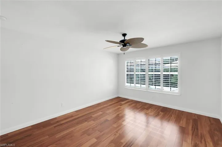 Empty room featuring wood finished floors and ceiling fan