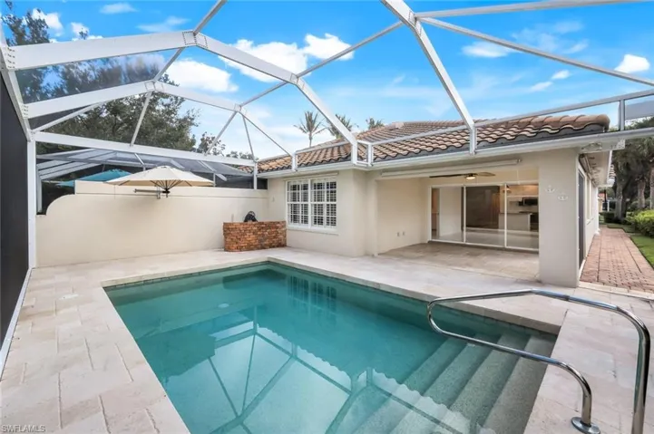 Swimming pool featuring a ceiling fan, a patio, glass enclosure, and a sunroom