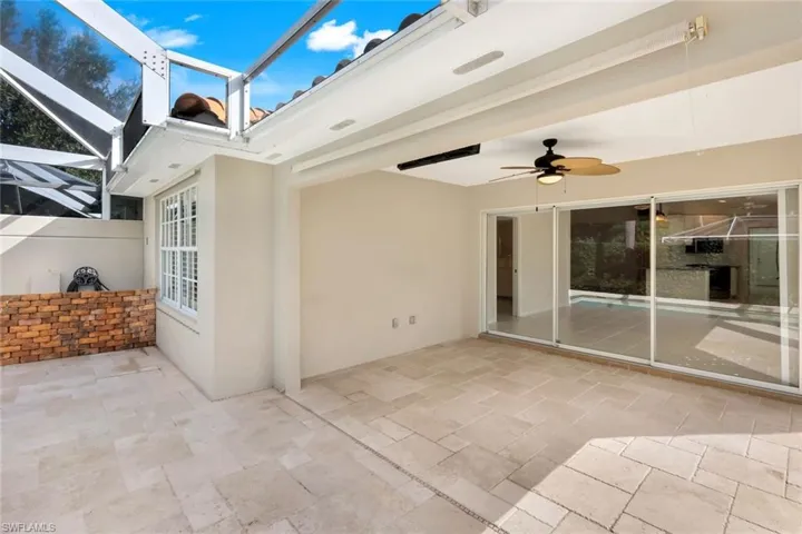 View of patio / terrace with a ceiling fan, a sunroom, and glass enclosure