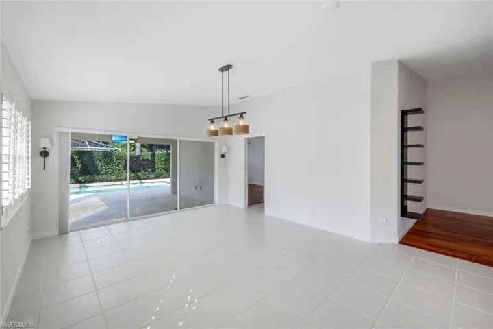 Spare room featuring light tile patterned floors and a sunroom