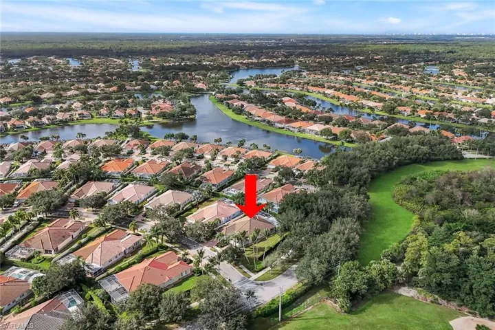 Aerial view of property's location featuring nearby suburban area and a large body of water