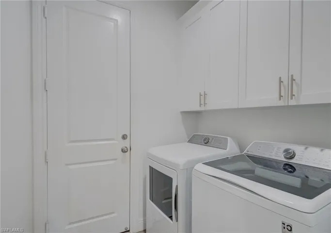 Laundry area with washing machine and clothes dryer and cabinet space
