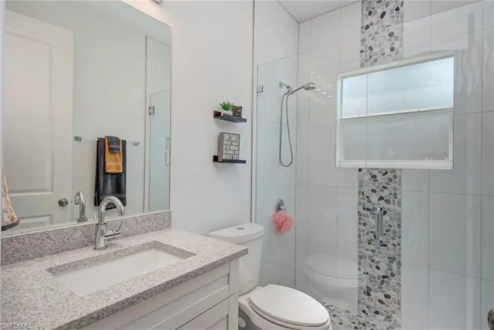 Full bathroom with a stall shower and vanity
