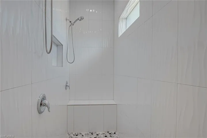 Bathroom view of a tile shower