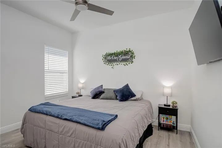 Bedroom with ceiling fan and light wood finished floors