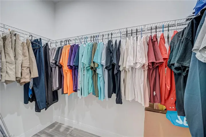 Walk in closet featuring wood finished floors