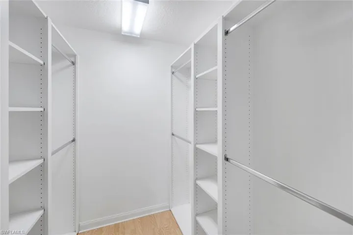 Walk in closet featuring light wood-style flooring