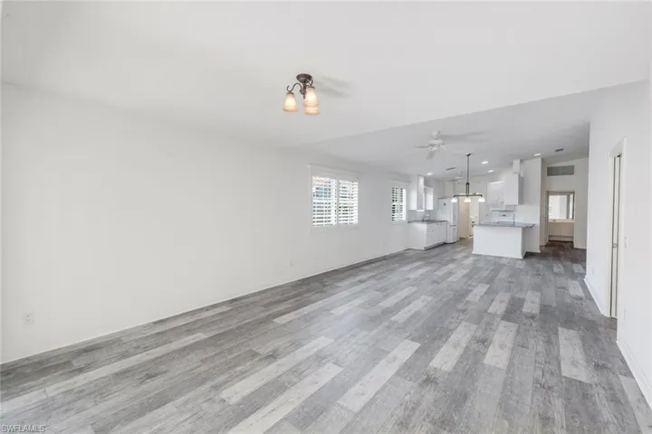 Unfurnished living room featuring light wood finished floors and ceiling fan
