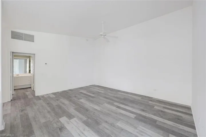 Empty room featuring ceiling fan and light wood-style floors