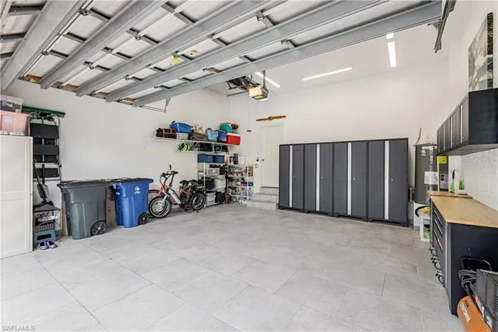 New hot water heater. Tiled garage floor.