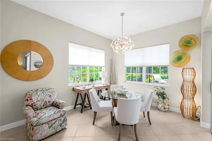 Dining space featuring a wealth of natural light and views of the lake and golf course.Hunter Douglas blinds.  So inviting!