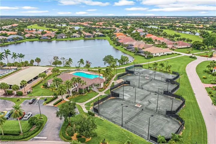 Aerial view of the fitness center and lighted Har-Tru tennis courts.