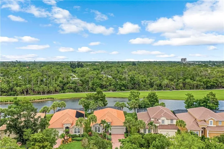 Birds eye view of property with a water and golf view.