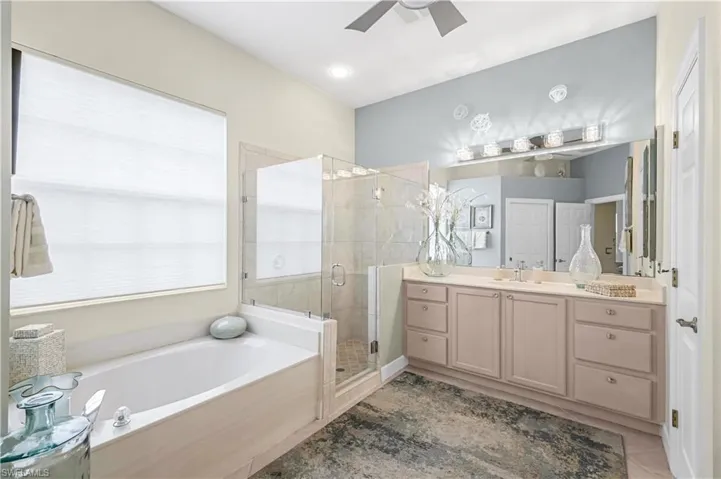 This exquisite ensuite bath offers a walk in shower with seamless glass enclosure, separate soaking zen tub and 2 comfor height vanities.