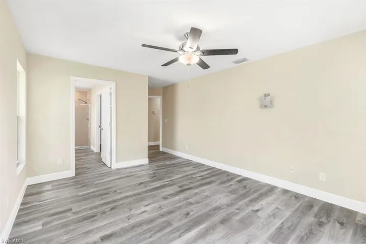 Unfurnished bedroom with ceiling fan and light hardwood / wood-style flooring