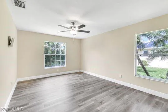 Spare room featuring light wood-type flooring and ceiling fan