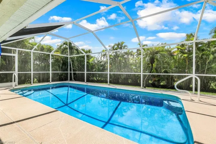 View of swimming pool with a patio and a lanai