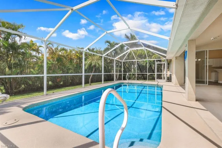 View of swimming pool featuring a lanai and a patio area