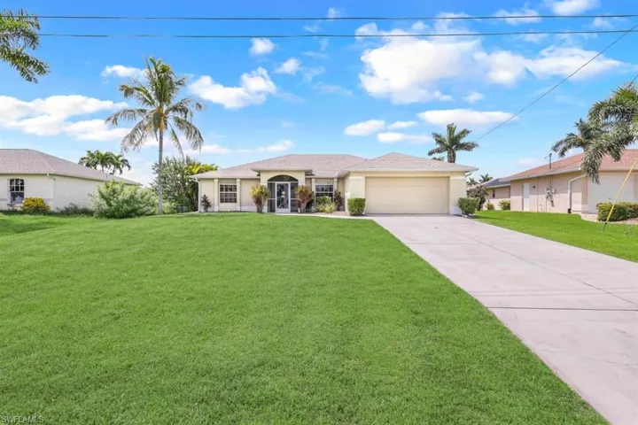 Single story home with a front yard and a garage