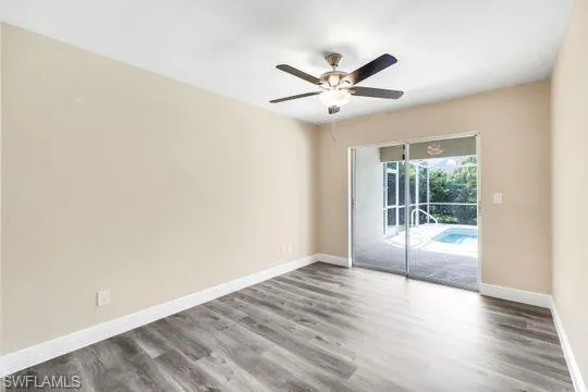 Unfurnished room featuring ceiling fan and hardwood / wood-style flooring