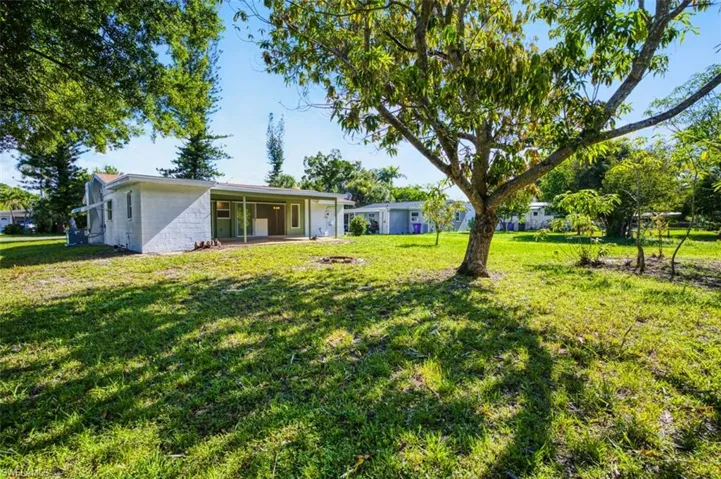 View of grassy yard featuring a patio area