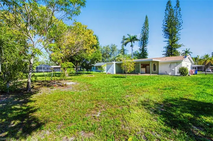 View of green lawn with a patio area