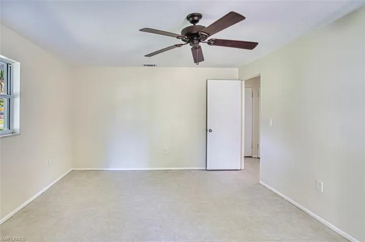 Spare room with baseboards and a ceiling fan